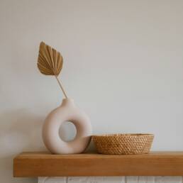 white ceramic vase on brown wooden table