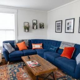 blue and brown couch with throw pillows